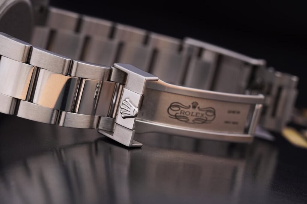 pexels-photo-9561302 A Rolex Logo on a Silver Watch Chain Lock